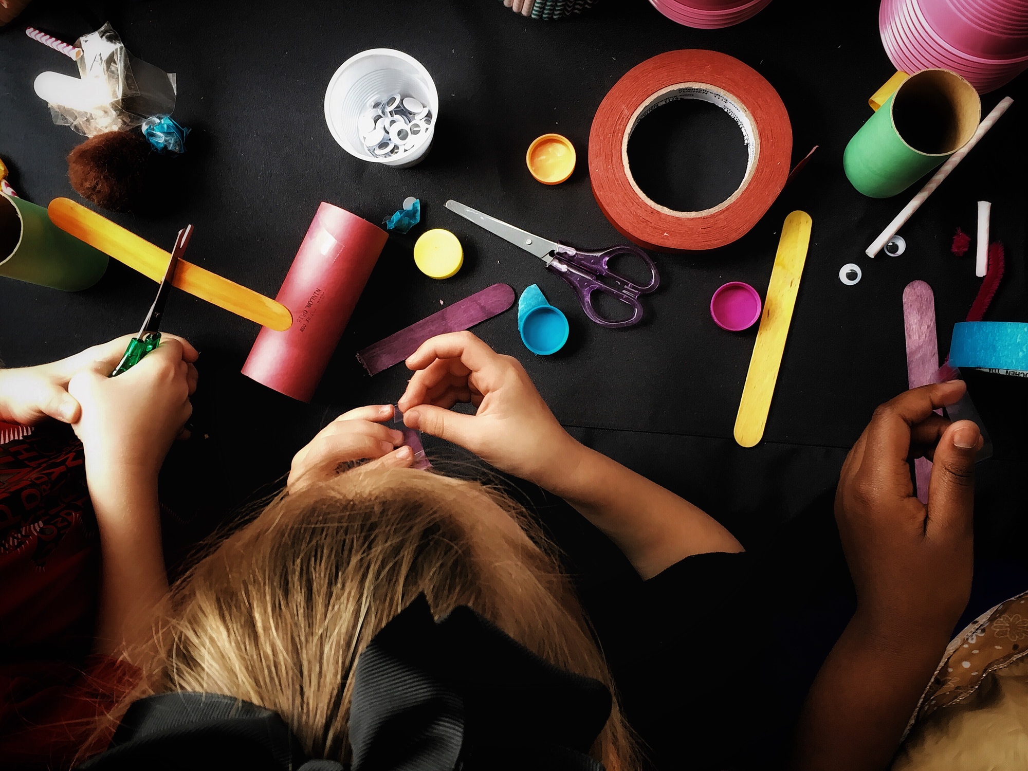 Kids doing arts and crafts on a table